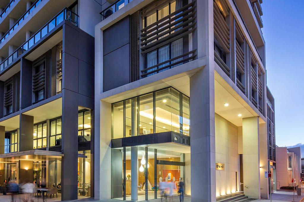 Modern hotel exterior on Newcastle's vibrant foreshore at dusk.