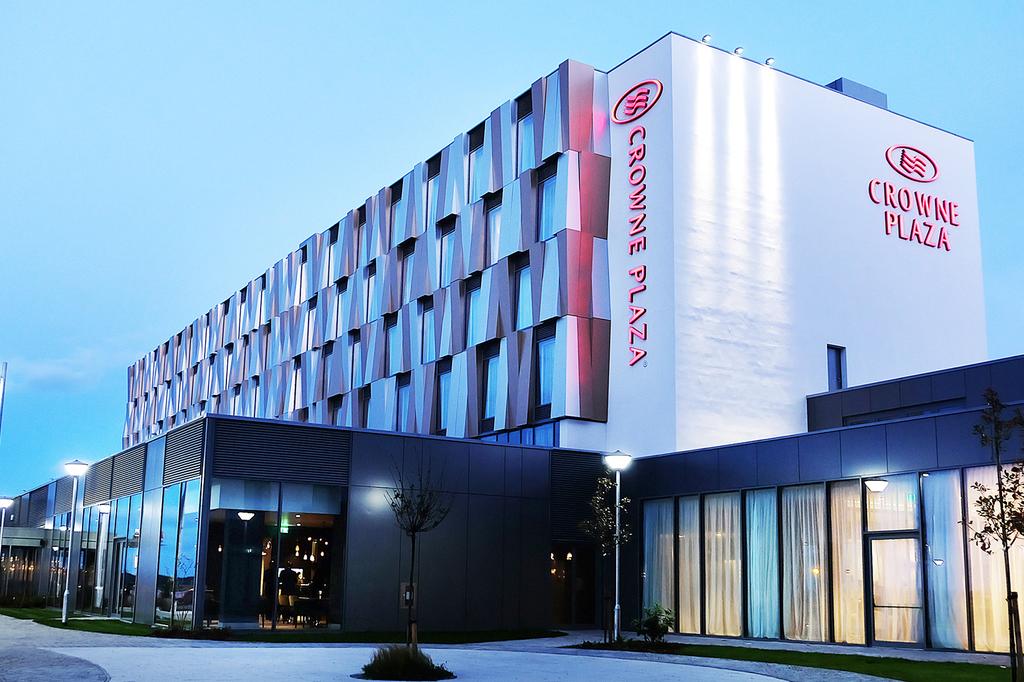 Modern exterior of Crowne Plaza Aberdeen Airport at dusk.
