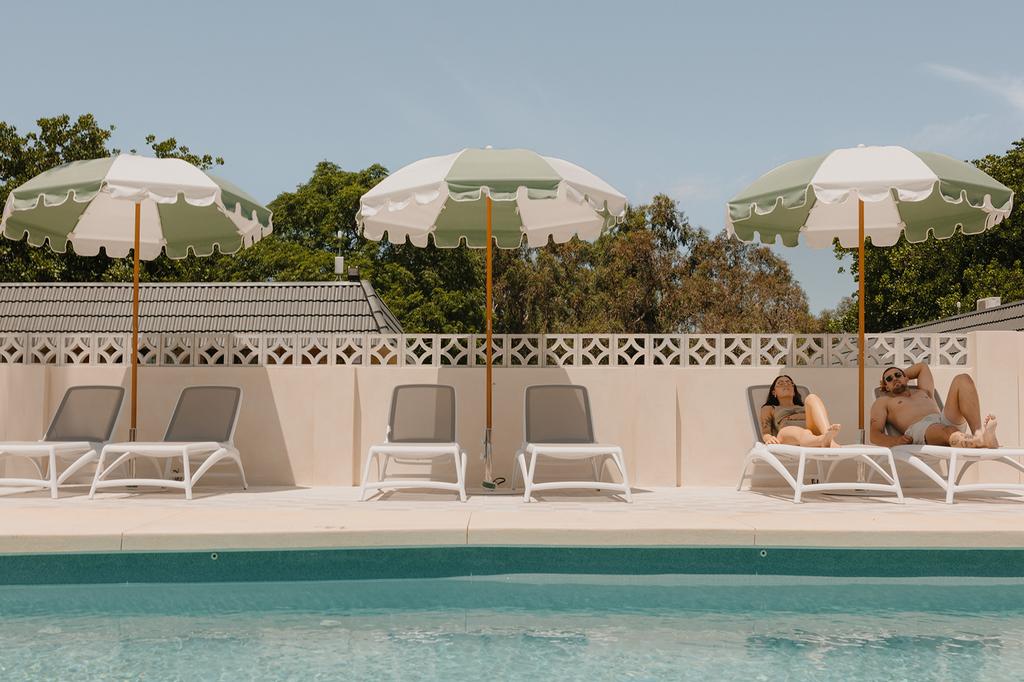 Guests relaxing by the pool at a Busselton retreat.