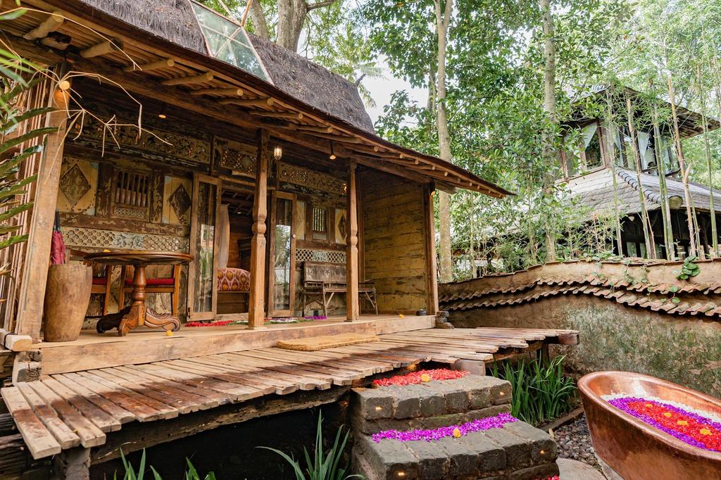 Organic bamboo house with an outdoor bath in a Balinese jungle setting.