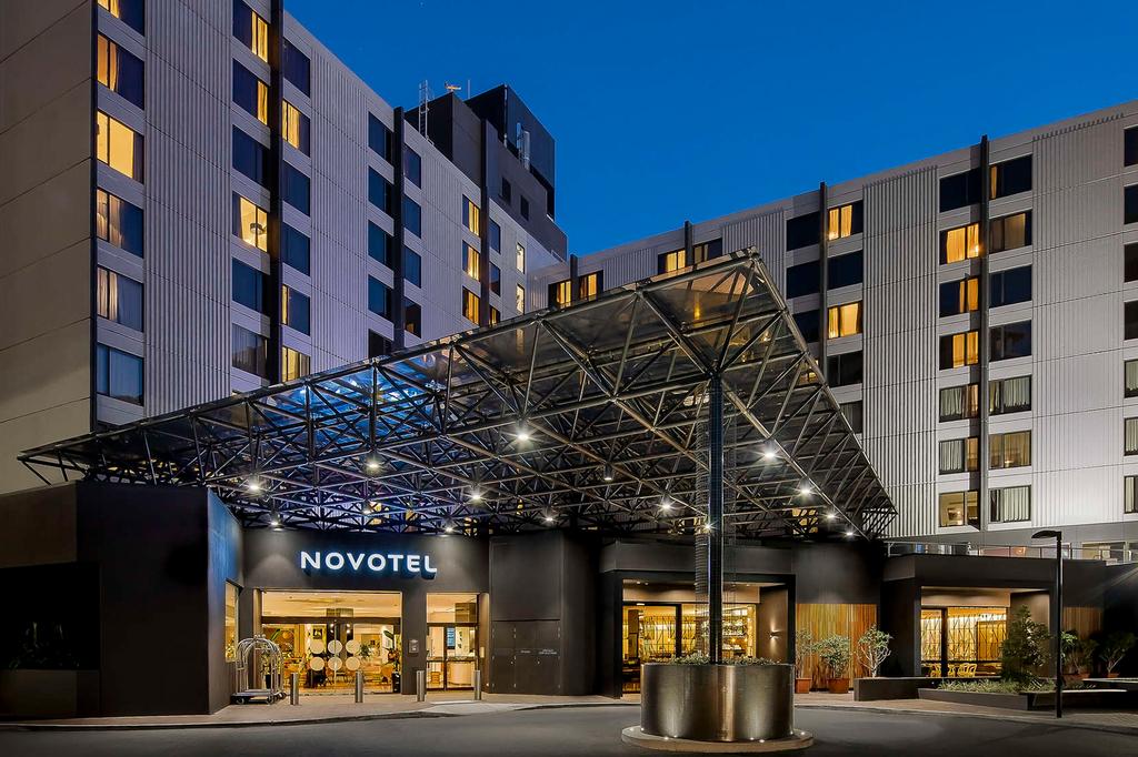 Stylish exterior of Novotel Sydney with illuminated entrance at night.