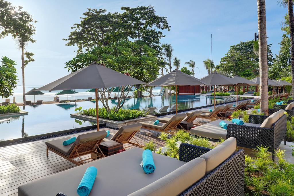 Luxurious poolside area at Nusa Dua beachfront resort.