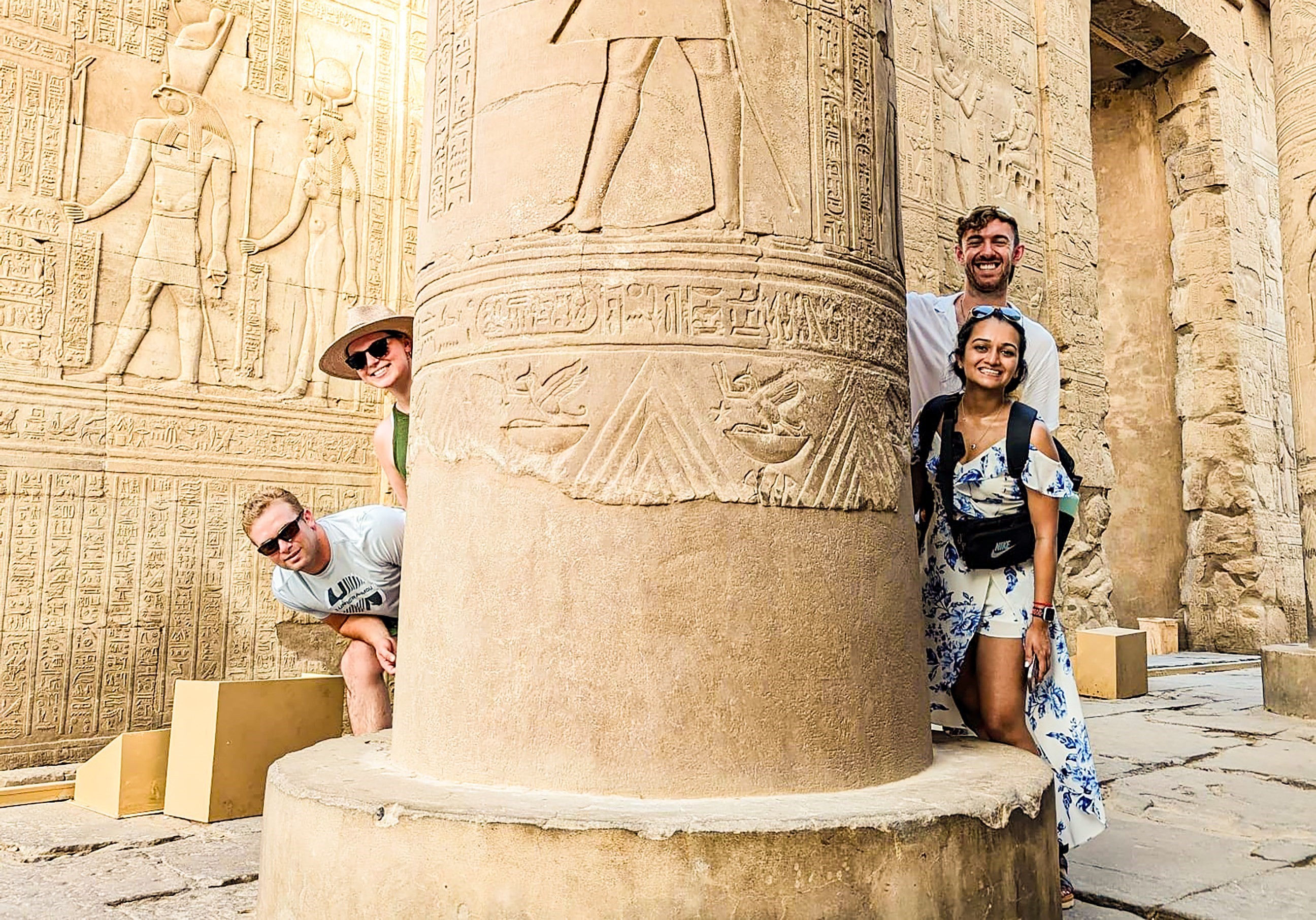 Travellers next to ancient Egyptian architecture, Egypt