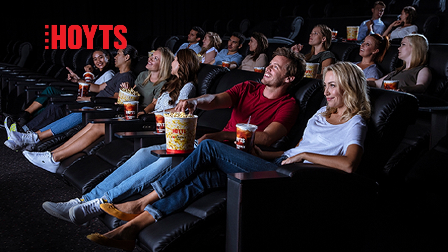 people watching in cinema sitting on lazy boy chair