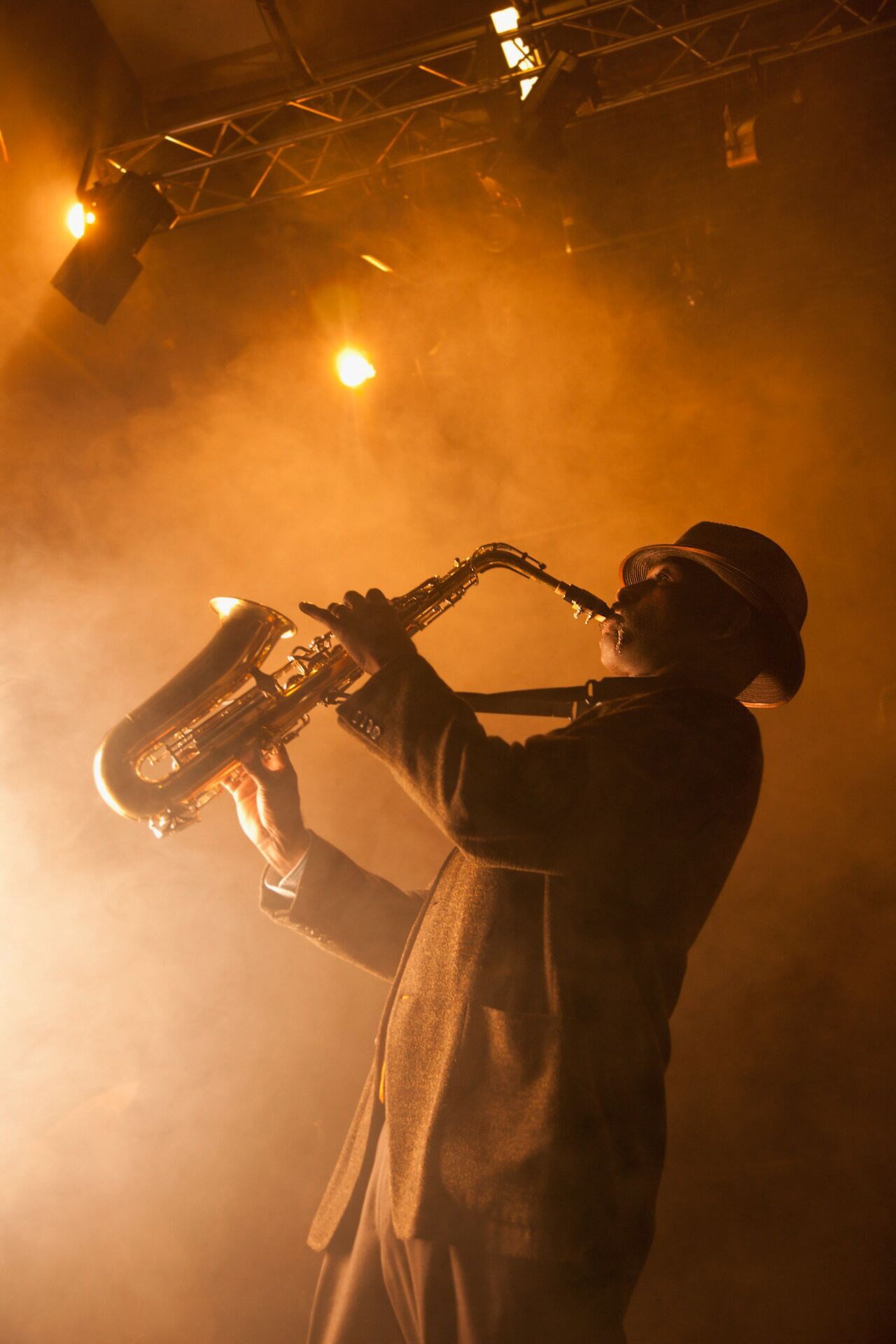 Large Black Musician Playing Saxophone On Stage, USA