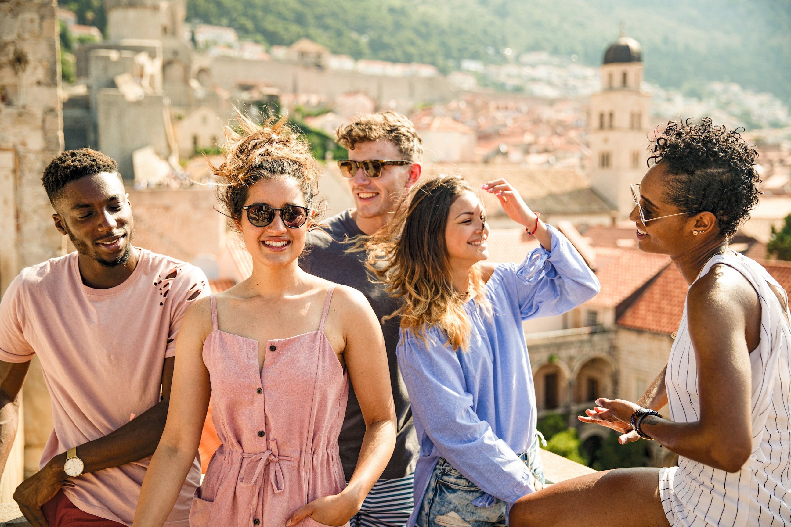 Travellers hanging out on the city walls of Dubrovnik Old Town in Dubrovnik, Croatia